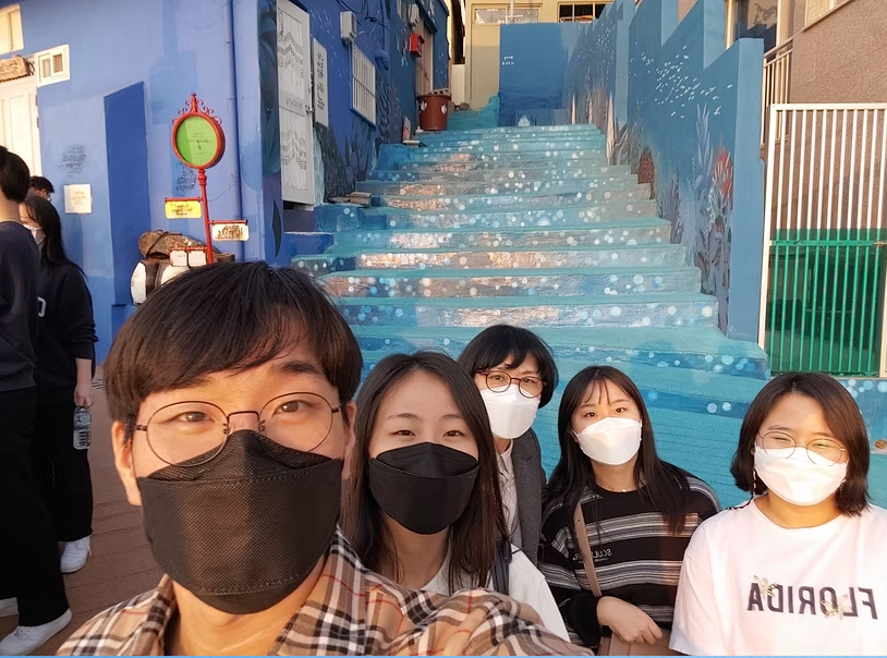 Team sightseeing at mural staircase